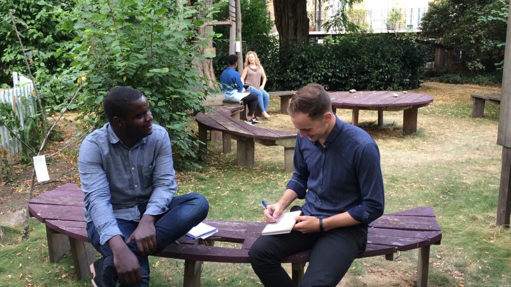 Two men workshopping in a green space by Groundwork London